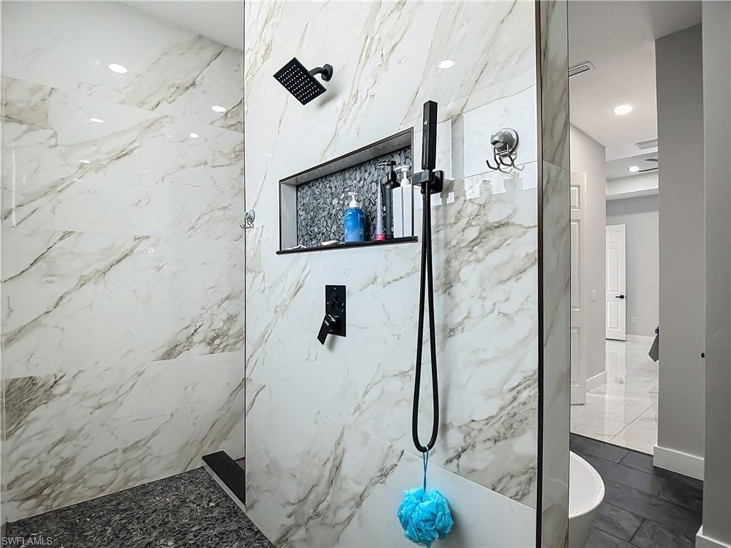 Bathroom featuring a marble finish shower