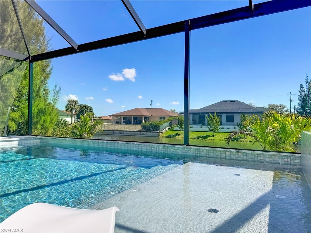 Outdoor pool with a lanai and a lawn