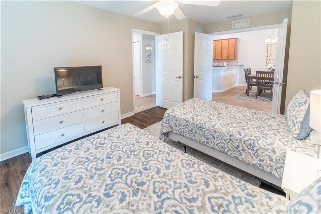 Bedroom featuring dark hardwood / wood-style floors and ceiling fan