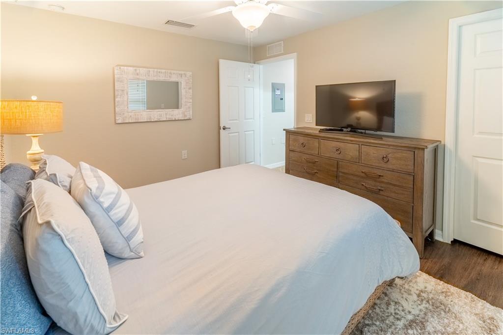 Bedroom with dark wood-type flooring and ceiling fan