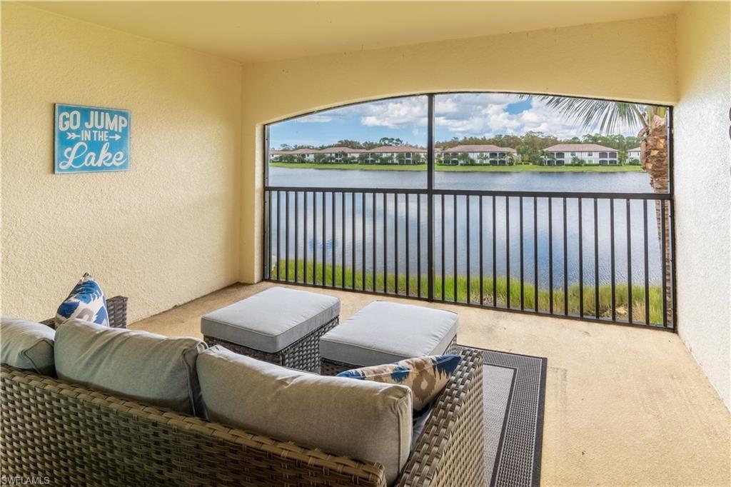 View of patio / terrace with a balcony and a water view