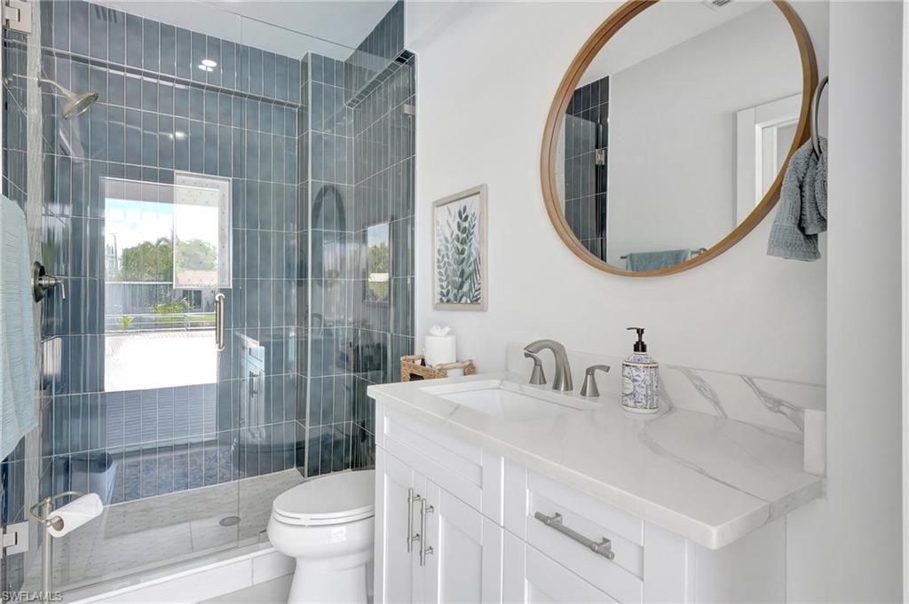 Bathroom with vanity and a stall shower
