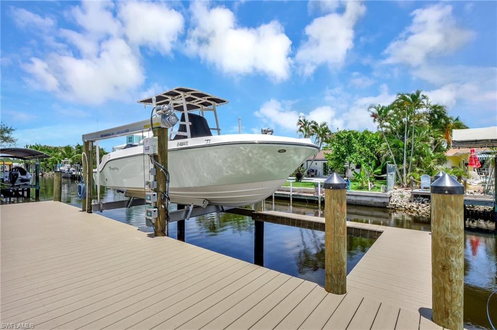 Dock area featuring boat lift and a water view