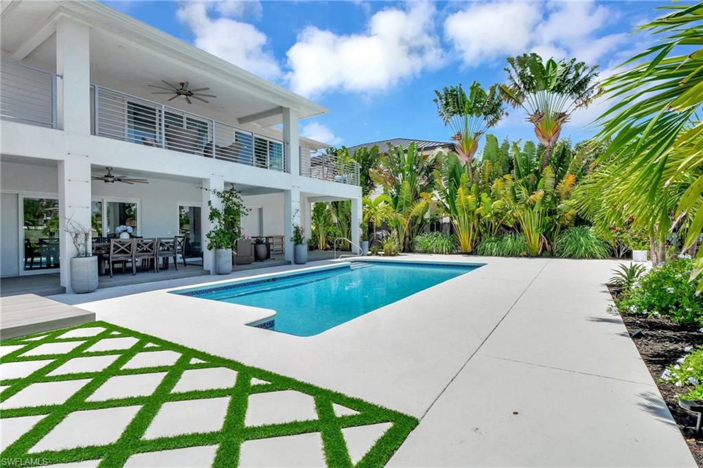 Swimming pool featuring outdoor dining area, a balcony, and a patio