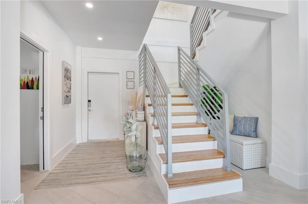 Stairway with baseboards and recessed lighting
