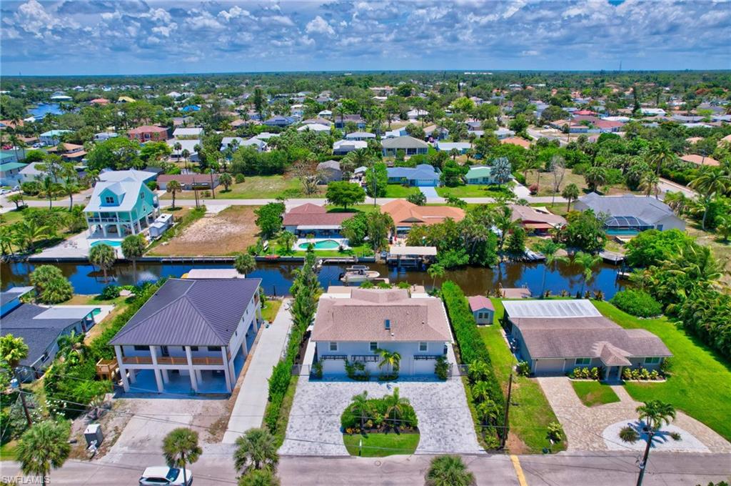Aerial perspective of suburban area featuring a nearby body of water
