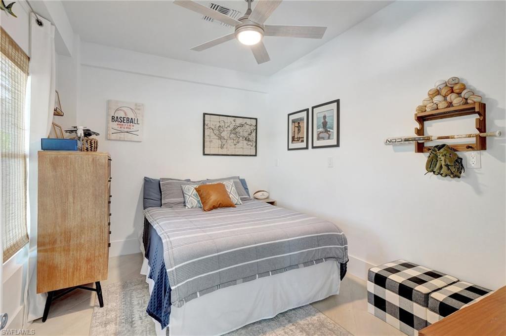 Bedroom with a ceiling fan and baseboards