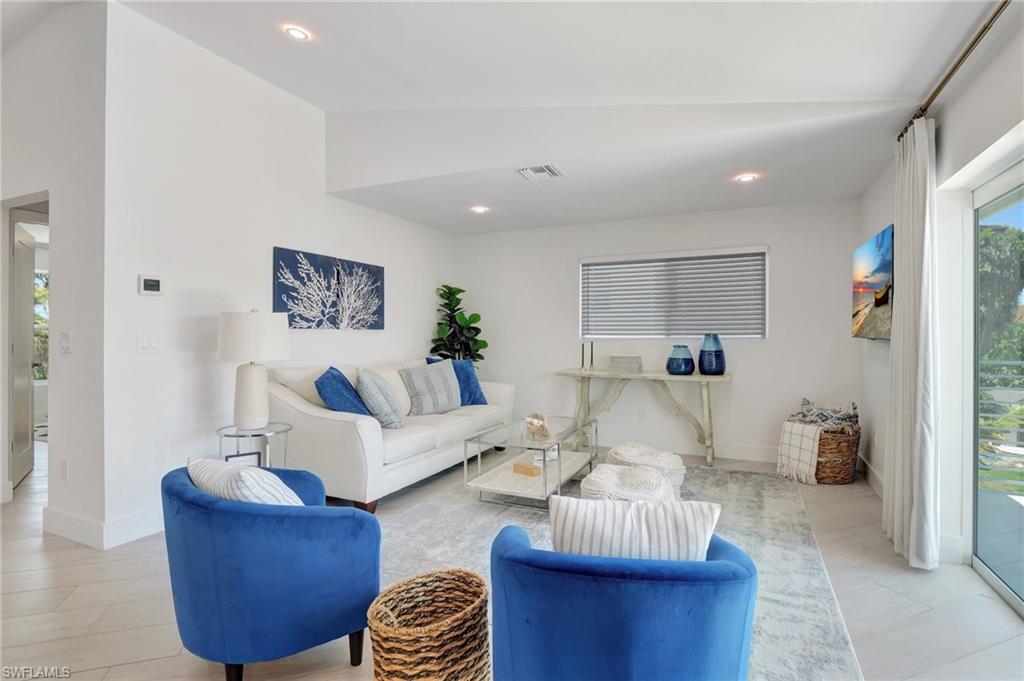 Living area with vaulted ceiling and recessed lighting