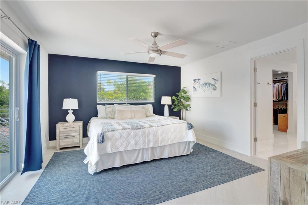 Bedroom featuring access to outside, a ceiling fan, and light tile patterned floors