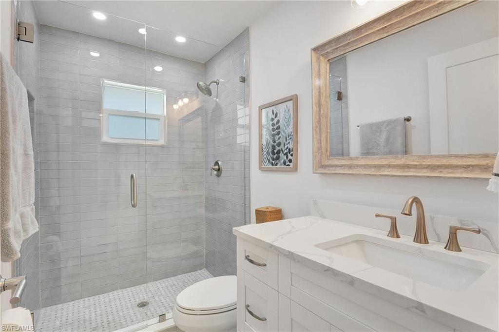Bathroom featuring vanity, a stall shower, and recessed lighting