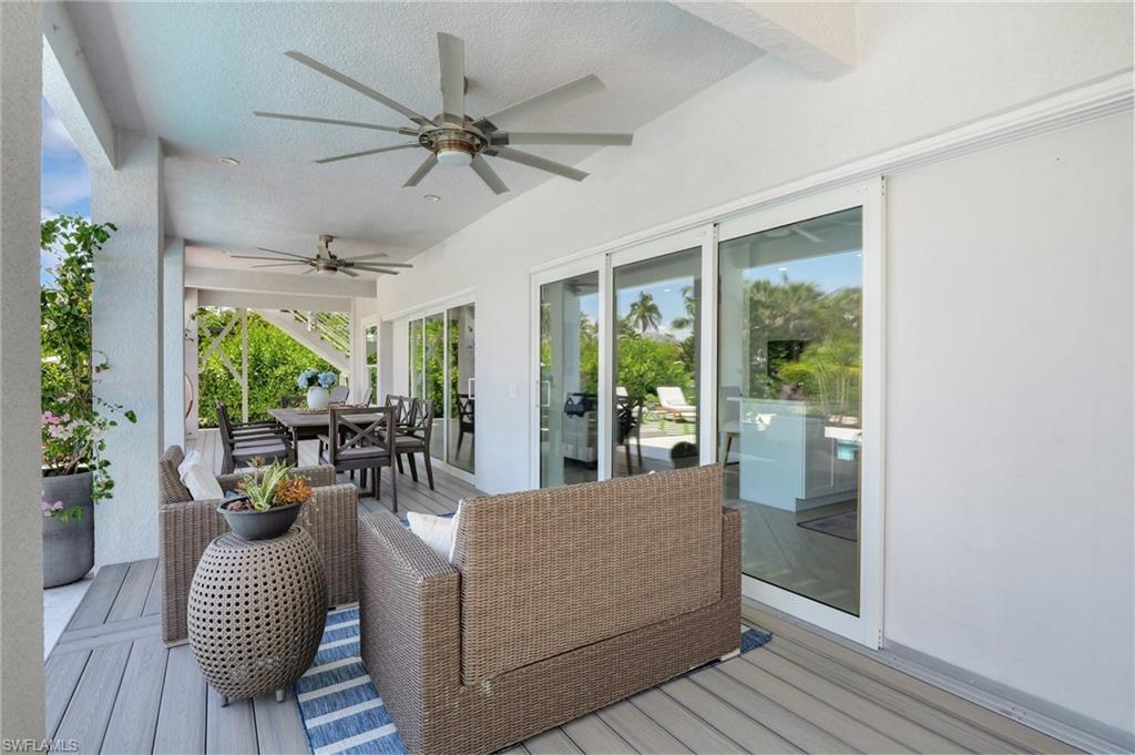 Deck with a ceiling fan, a grill, and outdoor dining space