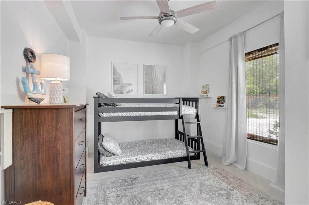 Bedroom with a ceiling fan and baseboards