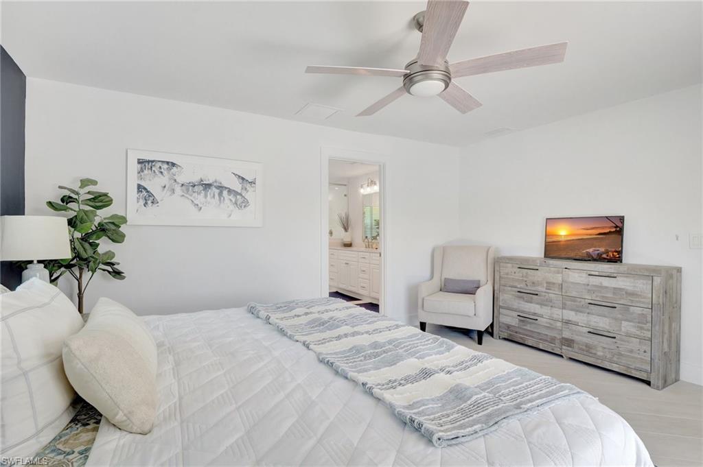 Bedroom with ceiling fan and ensuite bath