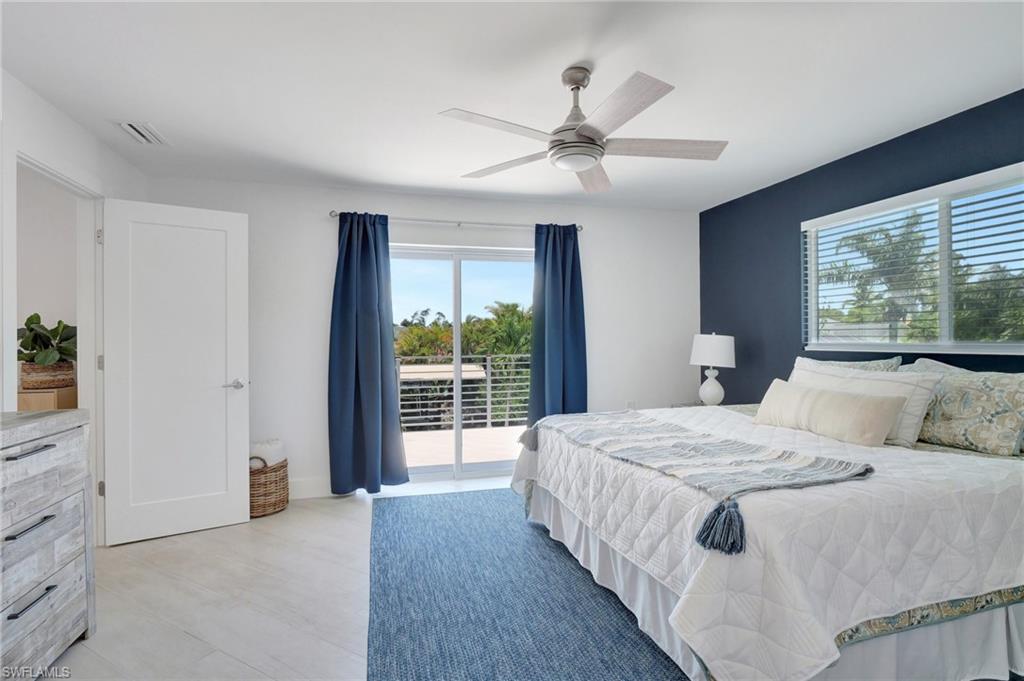 Bedroom featuring access to exterior, a ceiling fan, and light wood finished floors