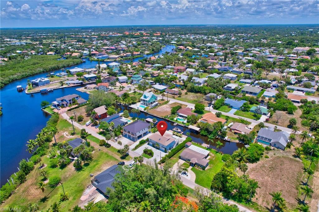 Aerial view of property's location featuring nearby suburban area and a nearby body of water