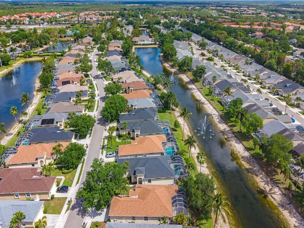 Aerial perspective showcasing multiple properties featuring private screened enclosures, waterside residences, private pools, and mature landscaping