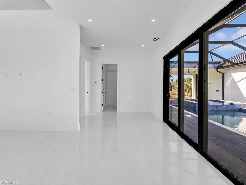 Empty room featuring recessed lighting and baseboards