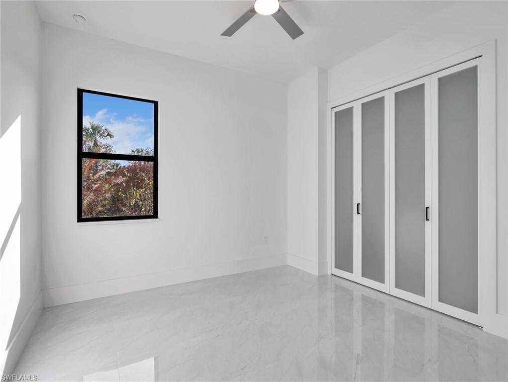 Unfurnished bedroom with a closet and a ceiling fan