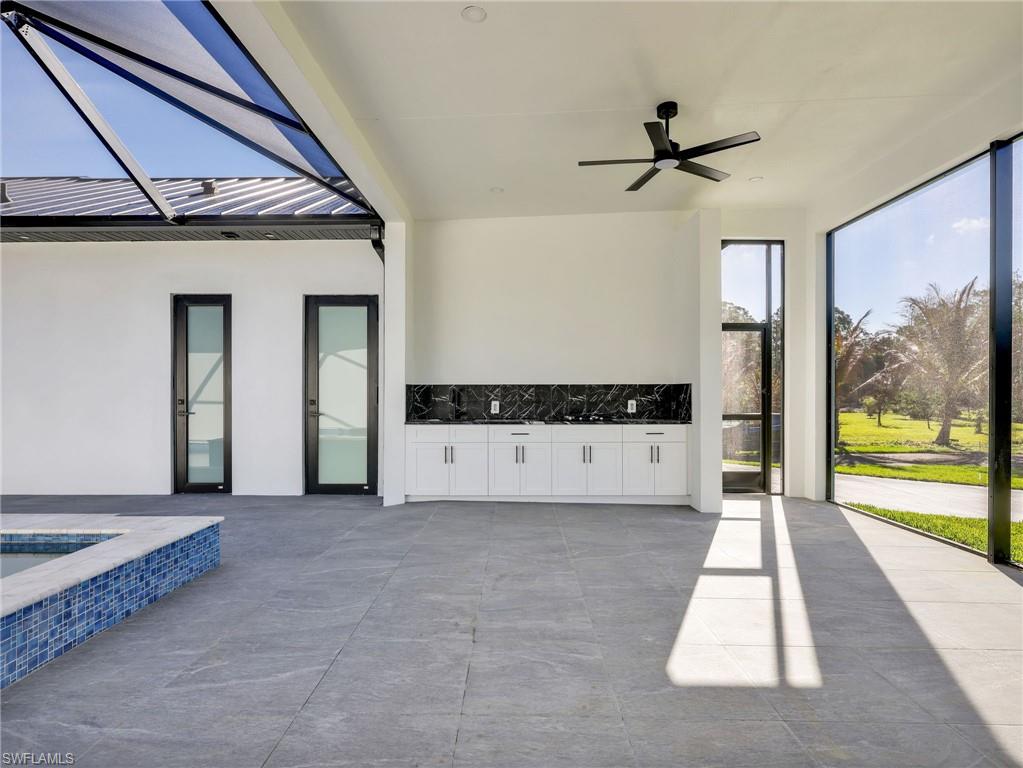 View of patio / terrace with a ceiling fan and glass enclosure