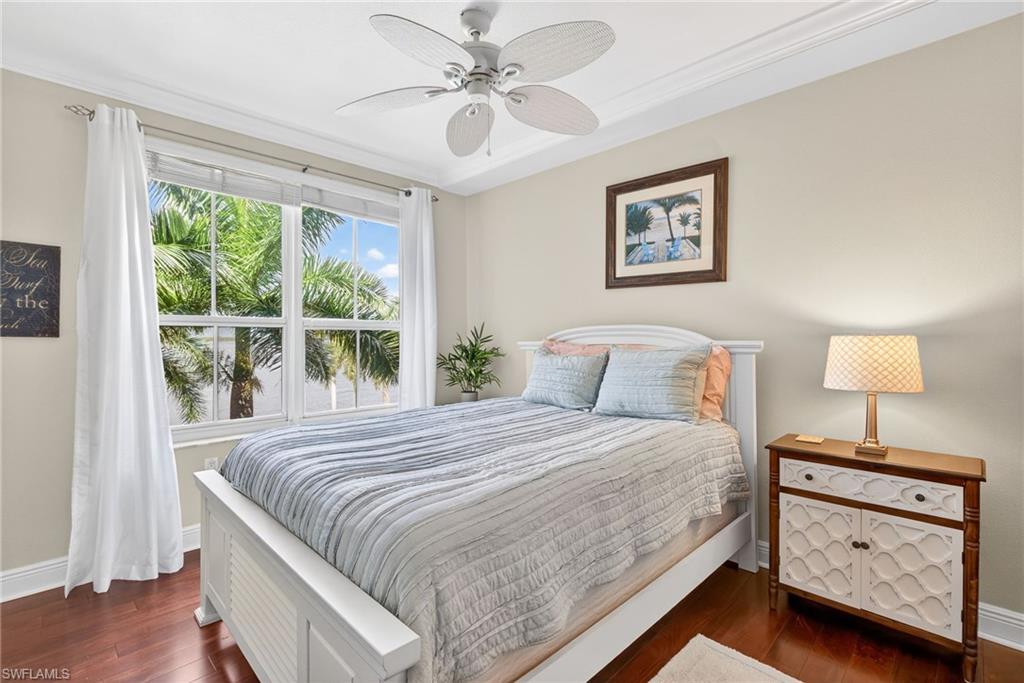 Bedroom with dark wood-style floors and ceiling fan