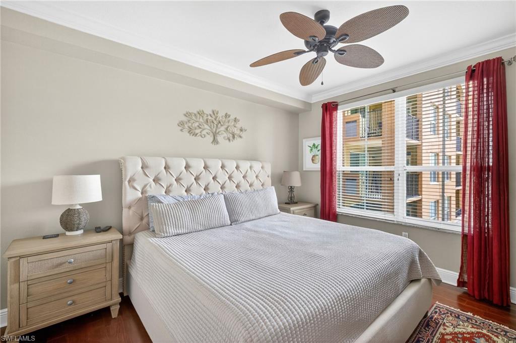 Bedroom featuring dark wood-type flooring, a ceiling fan, and ornamental molding