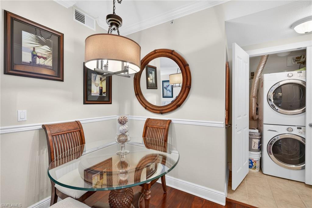 Dining space with stacked washer / dryer and ornamental molding