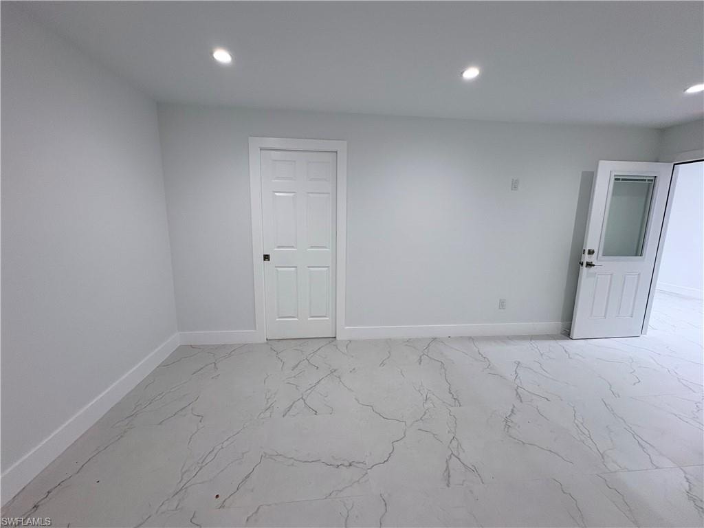 Unfurnished room with recessed lighting and light marble finish floors