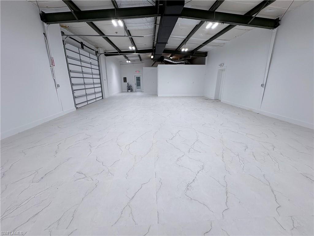 Garage featuring baseboards