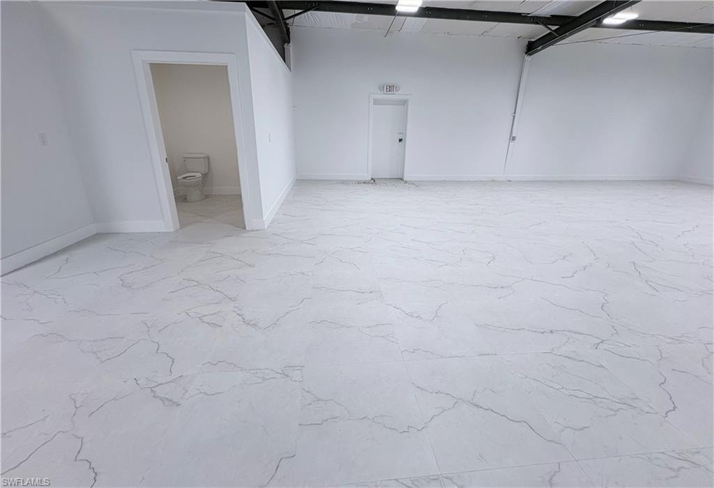 Garage featuring baseboards