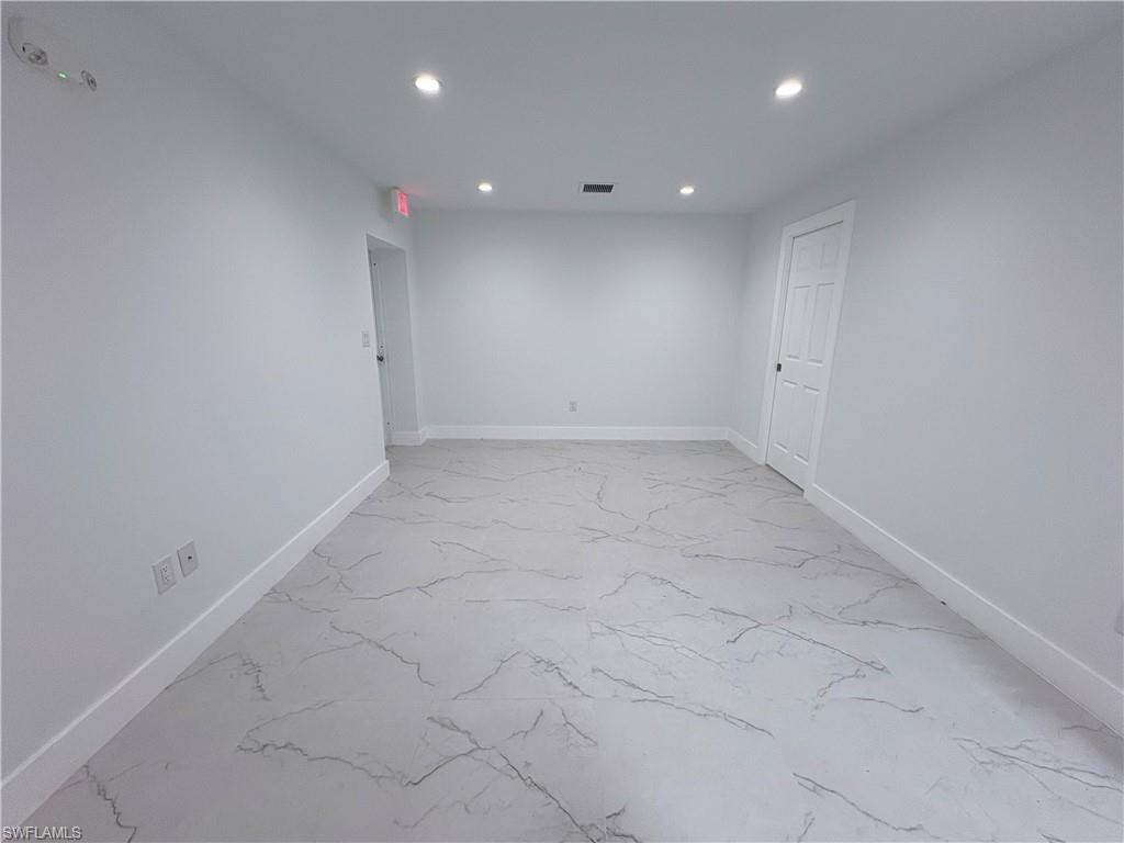 Empty room featuring recessed lighting