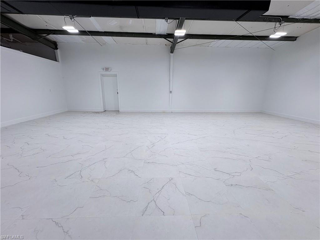 Garage featuring baseboards