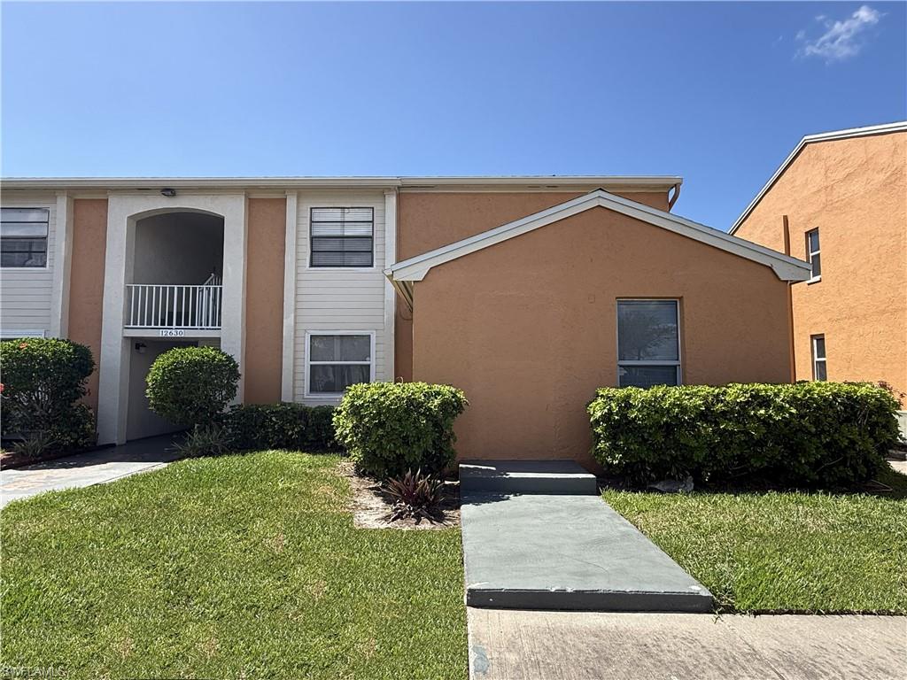 View of front of condo building; unit is lower right picture.