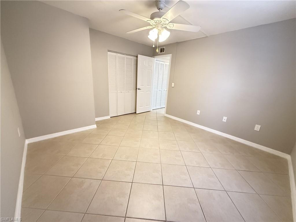 Unfurnished 2nd bedroom with light tile patterned flooring, ceiling fan, and a closet