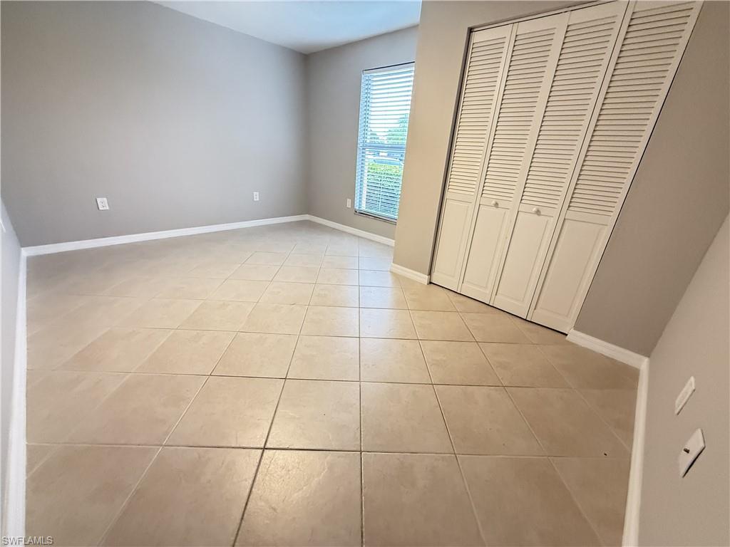 Unfurnished 3rd bedroom with light tile patterned flooring and a closet