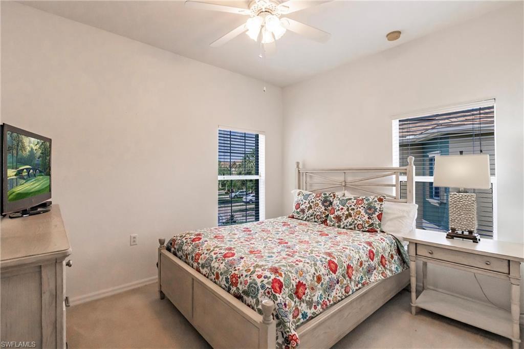 Bedroom featuring ceiling fan and light carpet