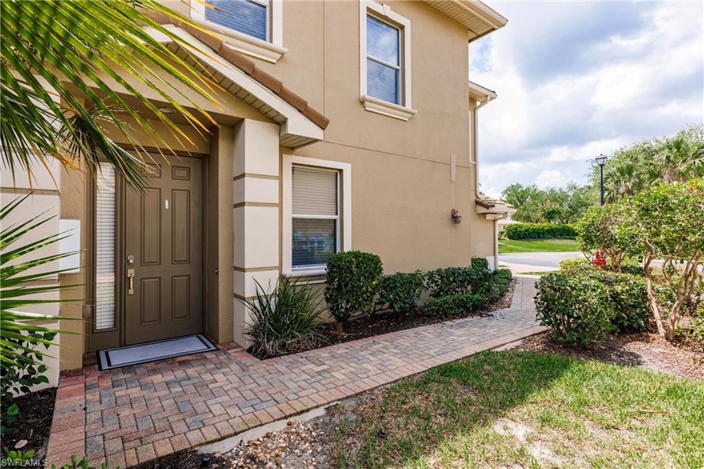 Entrance to property with stucco siding