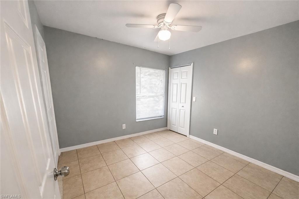 Unfurnished bedroom with a ceiling fan, a closet, and light tile patterned flooring