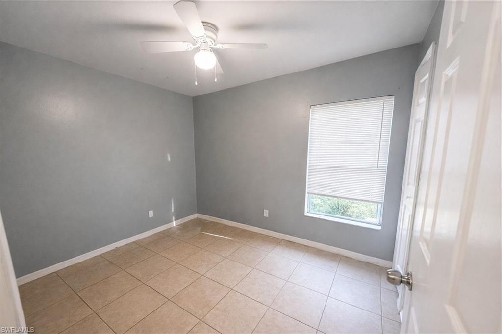 Unfurnished room featuring ceiling fan and light tile patterned floors