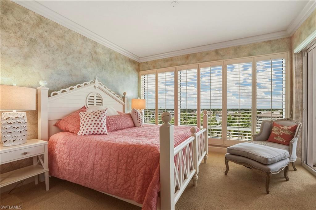 Bedroom with carpet, ornamental molding, and wallpapered walls