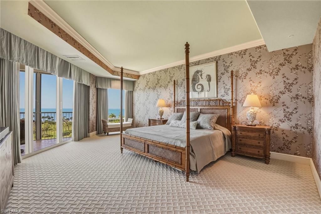 Bedroom featuring crown molding, a water view, light colored carpet, access to exterior, and wallpapered walls