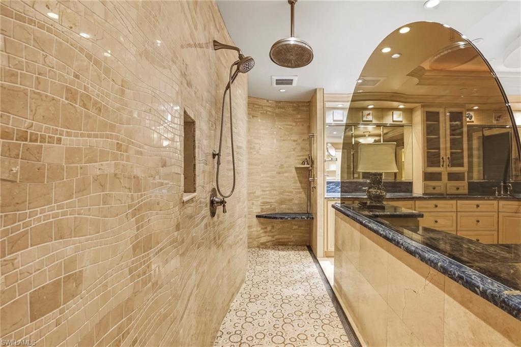 Bathroom featuring recessed lighting, a walk in shower, and vanity