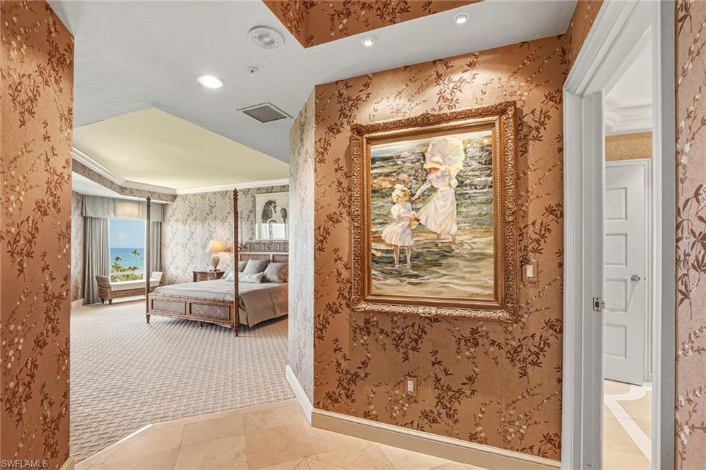 Hallway with recessed lighting, light tile patterned floors, wallpapered walls, crown molding, and light carpet