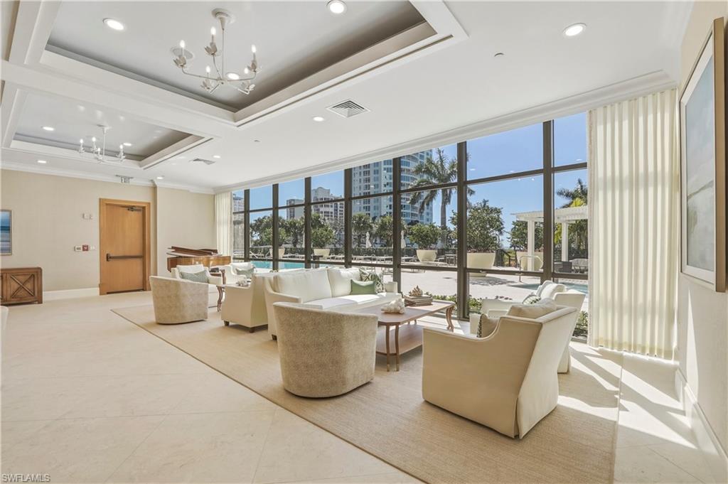 Building lobby with floor to ceiling windows and recessed lighting
