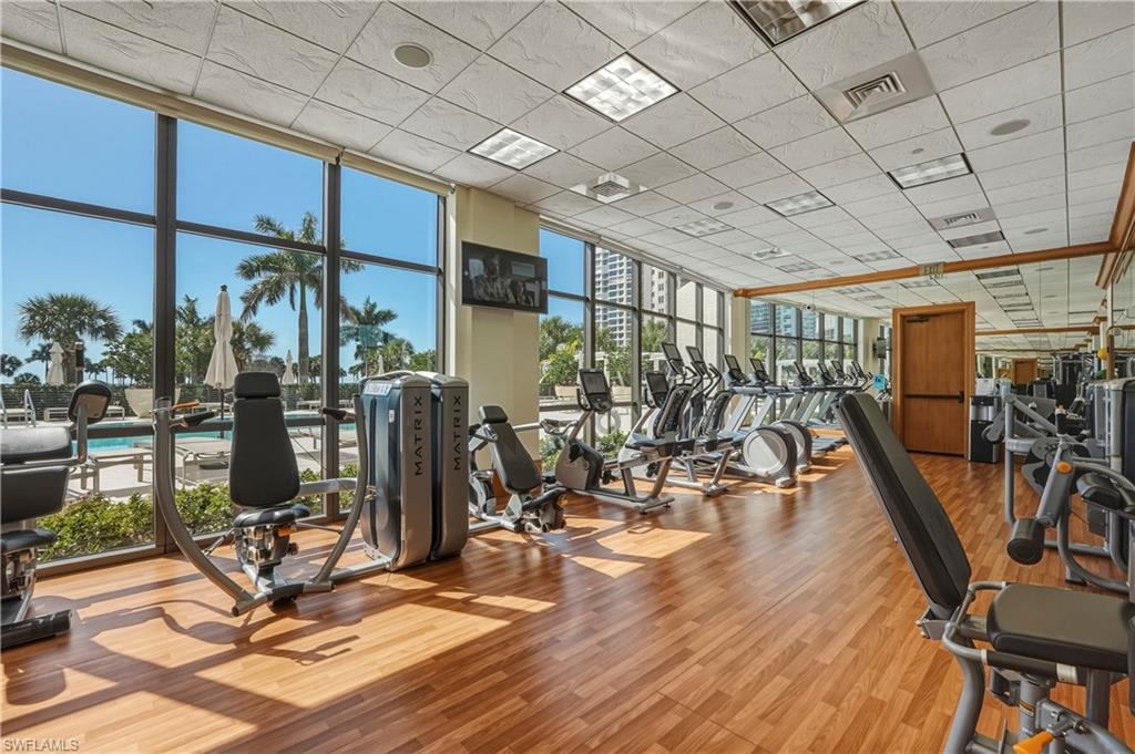 Gym with expansive windows and a paneled ceiling