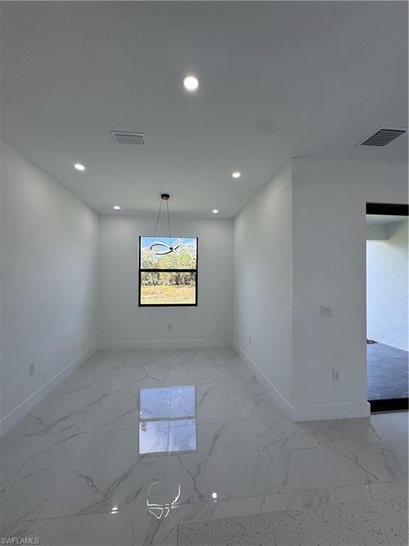 Spare room featuring recessed lighting and light marble finish floors
