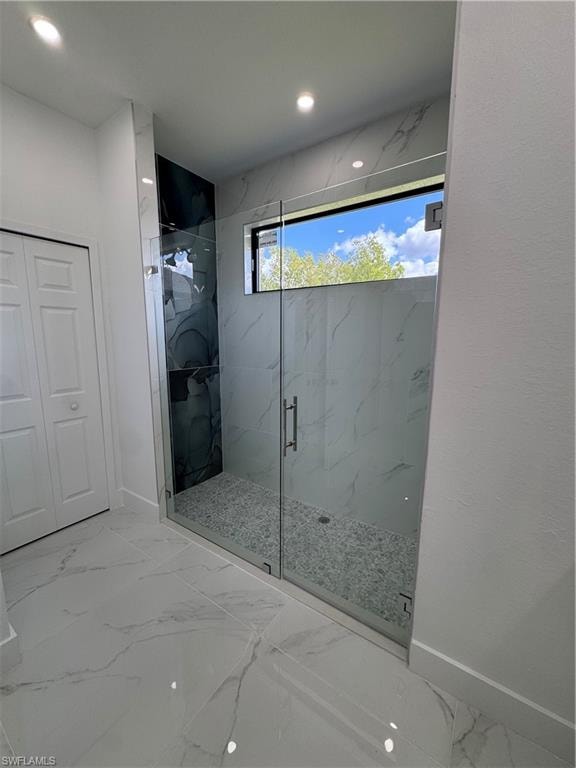 Full bathroom featuring a marble finish shower, light marble finish flooring, and recessed lighting