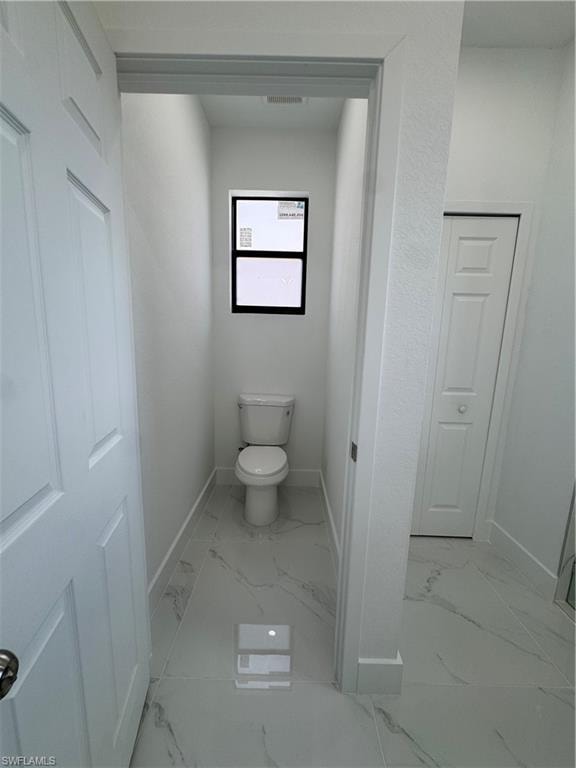 Bathroom with light marble finish flooring