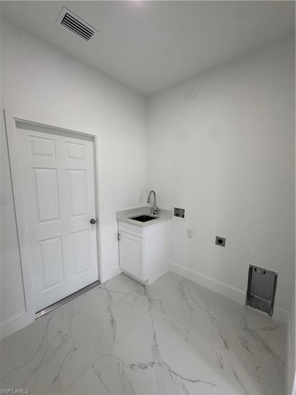 Laundry area with hookup for a washing machine, light marble finish floors, electric dryer hookup, and cabinet space