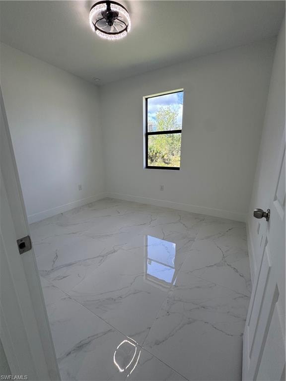 Empty room with baseboards and light marble finish flooring