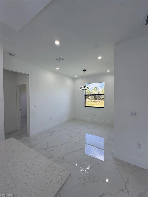 Spare room featuring recessed lighting and light marble finish floors